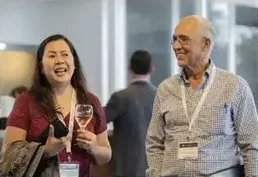 Two attendees talking at an evening reception
