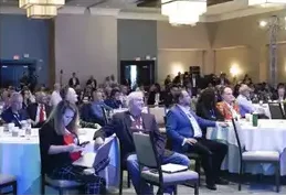 Investors seated at banquet tables during a session