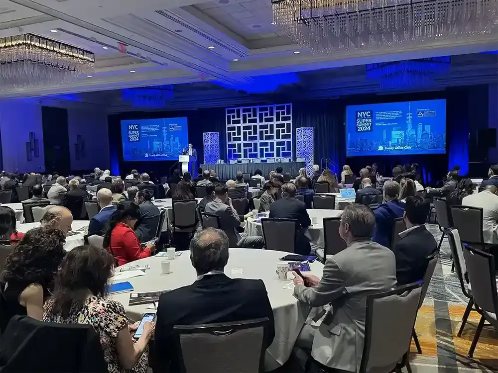 Attendees seated at round tables at a New York investor summit hosted by our team